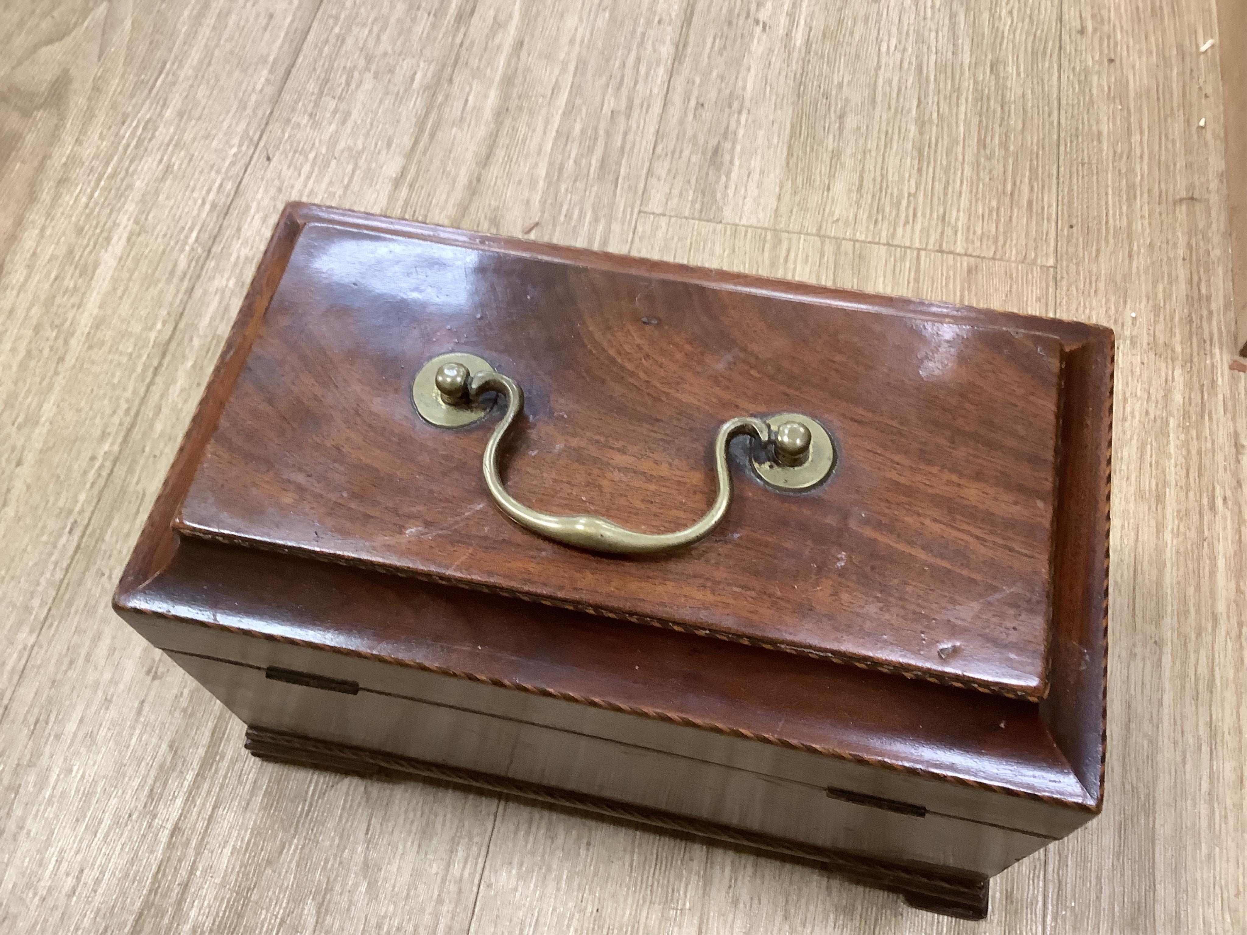 A George III mahogany tea caddy, containing tinned metal canisters, 25cm wide